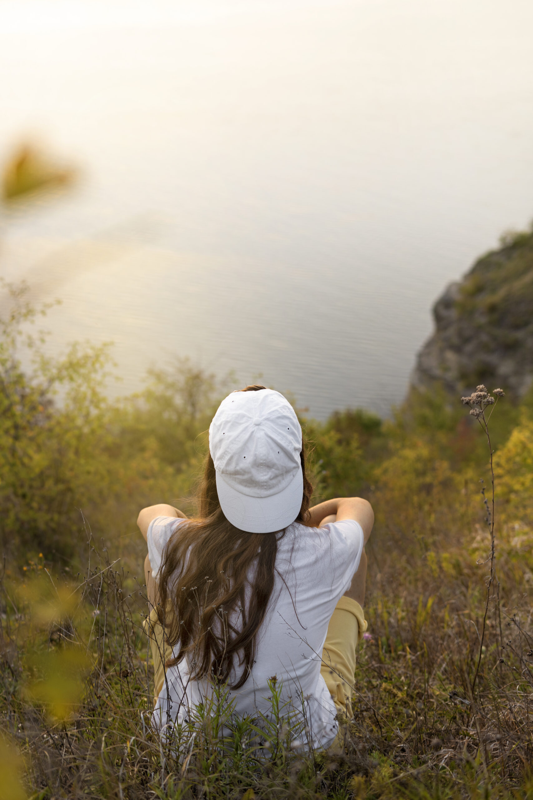 A woman resting, overlooking the water â€” healing and being made whole